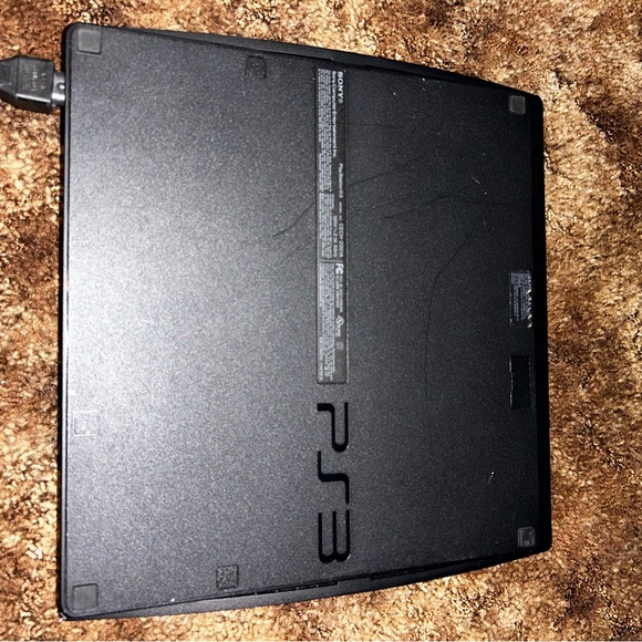 PlayStation 3 with controller and one game